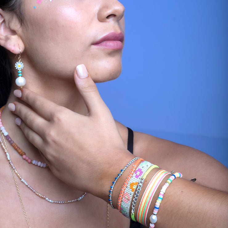 This stunning adjustable bracelet is handwoven using Japanese  glass beads and features flower print patterns in bright tones.  Wear yours stacked or solo to add a mood-boosting pop of color to any neutral look!  Details:      Japanese glass beads     Handwoven adjustable bracelet     Width11mm     Can be worn in the water