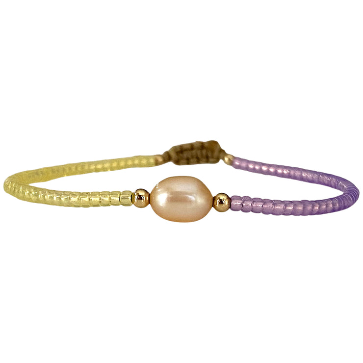 Make a confident statement with this beautiful handmade bracelet. This design is handwoven by our team of artisans using japanese glass beads,14k gold filled beads and a freshwater pearl.  This bracelet is elegant and femenine, making it the perfect accessory for any occasion.  Details  - Japanese glass beads   - 14 k gold filled beads  - Adjustable Bracelet  -Width: 2mm  -Can be worn in the  water