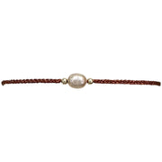 Make a confident statement with this delicate handmade bracelet. This design is handwoven by our team of artisans using metallic threads,14k gold filled beads and a freshwater pearl.  This bracelet is elegant and femenine, making it the perfect accessory for any occasion.  Details  - Metallic thread  - Freshwater pearl  - 14 k gold filled beads  - Adjustable Bracelet  -Width: 2mm  -Can be worn in the  wate