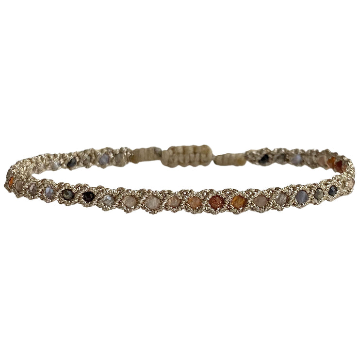 If you wish for simple elegance and versatility this bracelet is just for you. It is handwoven by our team of artisans using intermiexd semi-precious stones and metallic threads.  Details:  - Intermixed semi-precious stones  - Metallic threads  -Adjustable bracelet  -Width: 3mm