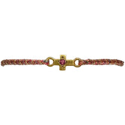 This delicate bracelet is handmade by our team of master artisans using metallic threads and a gold cross charm encrusted with a beautiful pink tourmaline stone. It's the perfect accessory to add a little sparkle in your life.  Details:      Pink tourmaline semi-precious stone     Gold Vermeil setting     Women bracelet     Adjustable handwoven bracelet     Width 5mm