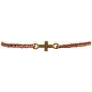 This delicate bracelet is handmade by our team of master artisans using metallic threads and a gold cross charm encrusted with a sparkling pink tourmaline stone. It's the perfect accessory to add a little sparkle in your life.  Details:      Pink Tourmaline semi-precious stone     Gold Vermeil setting     Women bracelet     Adjustable handwoven bracelet     Width 6mm