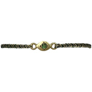 This delicate bracelet is handmade by our team of master artisans using metallic threads and a gold eye charm encrusted with a beautiful green tourmaline stone. It's the perfect accessory to add a little sparkle in your life.  Details:      Green tourmaline semi-precious stone     Gold Vermeil setting     Women bracelet     Adjustable handwoven bracelet     Width 5mm