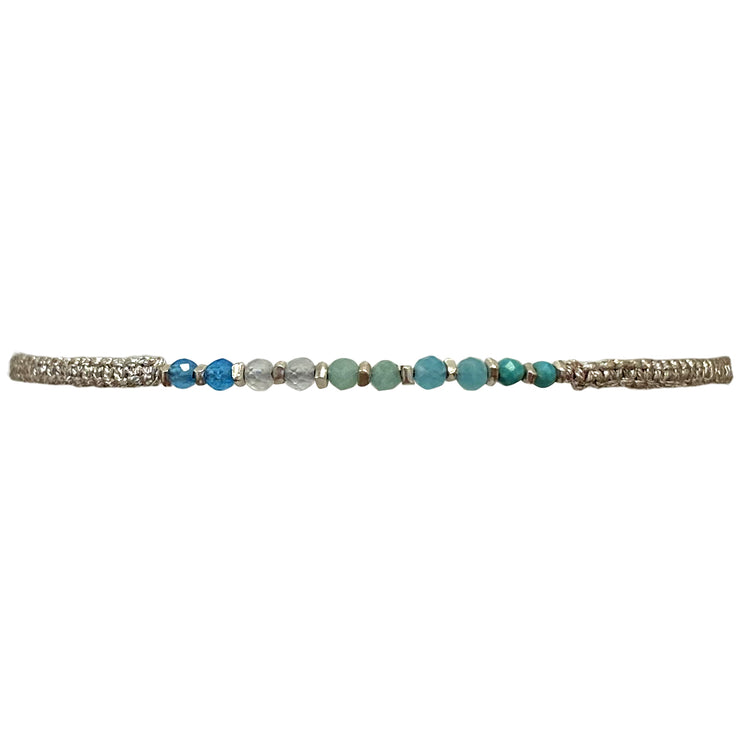 Represents Love of Humanity.  The Best Things In Life Are Unique, Affordable And Long Lasting. Style Your Look With This Unique Handwoven Bracelet.  Details:  -Intermixed semi-precious stones  -925 silver faceted beads  -Metallic threads in silver  -Adjustable bracelet   -Width: 3mm 
