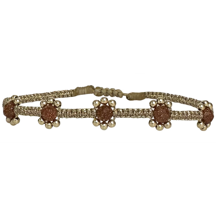 Add to your jewellery box this delicate and feminine design. This lilac bracelet is handwoven using metallic threads, Hessonite semi-precious stones and 14k gold filled beads creating little flowers to adorn your wrist.   Wear it with your favourite accessories !  Details:  - Hessonite semi-precious stones  -14k gold filled beads   -Handwoven using  metallic threads  -Adjustable bracelet   -Width: 5mm  - Can be worn in the water