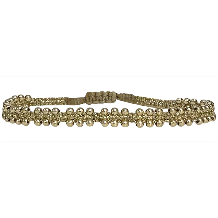 This delicate and beautiful bracelet is handwoven by our team of artisans using 14K gold filled beads and metallic threads.   You can wear it with your favourite bracelets all season long.   Details:  -14k gold filled beads details   -Adjustable bracelet  -Width: 4mm  -Can be worn in the  water