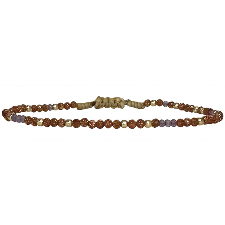 This delicate jewel is handmade using an array of semi-precious stones and 14k gold filled beads. This beauty will be one of your favs bracelets as you can wear it with any accessories or outfits. Give to your looks a touch of elegance and sparkle !  Details:  - Amethyst and gold sandstone semi-precious stones  -14 k gold filled beads  - Adjustable bracelet  - width: 2mm  -Can be worn in the water