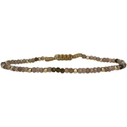 This delicate jewel is handmade using an array of semi-precious stones and 14k gold filled beads. This beauty will be one of your favs bracelets as you can wear it with any accessories or outfits. Give to your looks a touch of elegance and sparkle !  Details:  - Chocolate moonstone and gold obsidian semi-precious stones  -14 k gold filled beads  - Adjustable bracelet  - width: 2mm  -Can be worn in the water