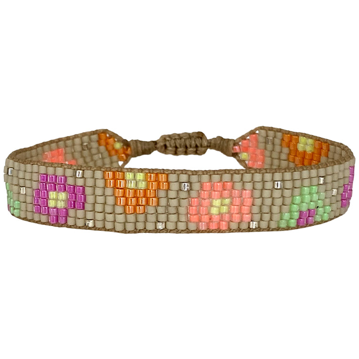 This stunning adjustable bracelet is handwoven using Japanese  glass beads and features flower print patterns in bright tones.  Wear yours stacked or solo to add a mood-boosting pop of color to any neutral look!  Details:      Japanese glass beads     Handwoven adjustable bracelet     Width11mm     Can be worn in the water