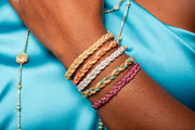 The metallic fuchsia threads catch the light, creating a dazzling effect that is sure to turn heads. Whether you're attending a special occasion or looking to add a pop of color to your daily outfit, this bracelet offers the perfect solution.