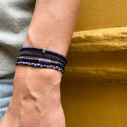 This cool bracelet is adorned with lapis lazuli stones. The highlights are silver Beads and one original african trade bead.  This bracelet looks great worn solo or layered with other pieces.  Details:  -Men's bracelet  -Original african trade bead  -Lapis lazuli stone  -sterling silver details  -Adjustable bracelet   -Width 4mm  -Can be worn in the water