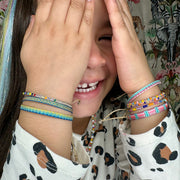  Barcelet Bliss!! This handmade wonder is the perfect splash of color and joy for the little ones!! They will never want to take them off, so let them play and play all day long!!  Details:  -Handmade Bracelet for kids  - Handwoven using Polyester  -Can be worn in the water - Width 3mm  -Can be worn in the  water