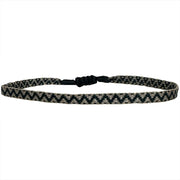 This bracelet features a brown strap with a black strip running down the center, creating a unique and eye-catching contrast.