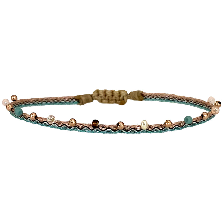 This LeJu bracelet has been handwoven in Colombia by our team of artisans using Polyester threads and a mix of 14K rose gold filled beads and japanese glass beads.  This can be worn solo or with your favourite pieces.  Details:      Polyester threads     Spinel stone     14k rose gold filled details       Handwoven adjustable bracelet     Width 2m