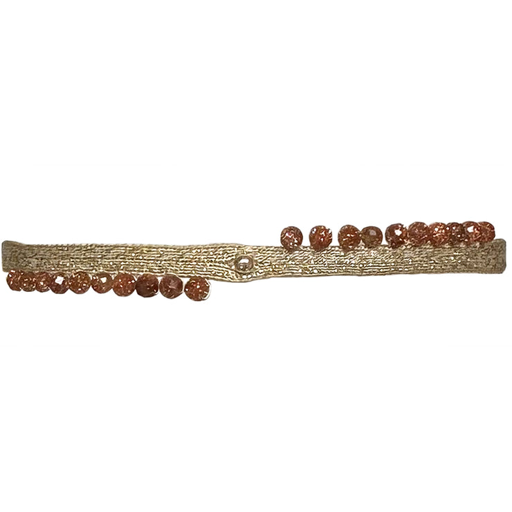 This LeJu bracelet has been handwoven in Colombia by our team of artisans using polyester threads featuring a 14K gold filled bead and gold sandtone semi-precious stones. Balancing the body, mind and spirit.  Details:  - Gold sandstone  semi-precious stones  - 14K gold filled bead  - Width 3mm  -Women bracelet  - Adjustable bracelet  -Can be worn in the  water