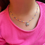 This  beautiful kids necklace is handmade in Colombia by our team of master artisans using japanese glass beads and a mother of pearl elephant charm.  How adorable is this necklace? Fabulous and fun with vibrant colors, it’s a great gift idea for any child.  Details:  -Kids  - Japanese glass beads  - Mother of pearl charm   - Lenght 