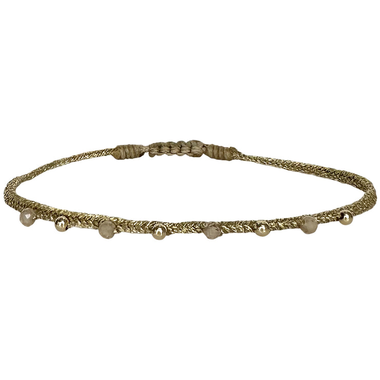 This bracelet has been handwoven in Colombia by our team of artisans using  metallic threads and zircon semi-precious stones and 14k filled beads.  Wear it with your favourite accessories .  Details:  - Zircon semi-precious stones  - Handwoven using metallic threads  - Width 3mm  - Adjustable bracelet  -Can be worn in the water