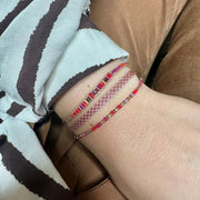 Handmade Set of Three Bracelets in Red and Fucsia Tones.