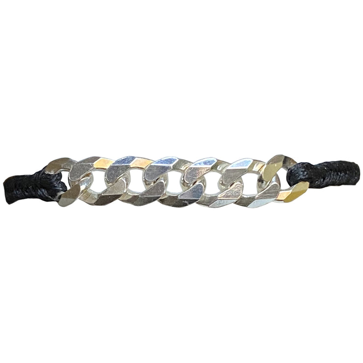   This bracelet has been handwoven in Colombia by our tema of master artisans. It features a strap in black tones with a central chain in 925 sterling silver. This masculine design looks great worn solo or stacked with other pieces.  Details:      925 sterling silver centrpiece     Italian wax threads     Adjustable handwoven bracelet     Width 7mm      Can be worn in the water