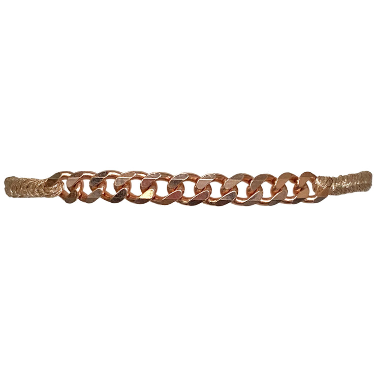 This delicate bracelet has been handwoven in Colombia by our team of master artisans using metallic threads. It features a strap in copper tones with a central chain in 24 rose gold vermeil. This femenine design looks great worn solo or stacked with other pieces.  Details:      24 rose gold vermeil centerpiece     Metallic threads     Adjustable handwoven bracelet     Width 5mm