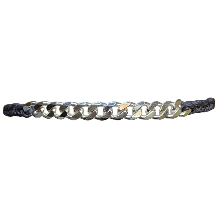 This bracelet has been handwoven in Colombia by our tema of master artisans. It features a strap in grey tones with a central chain in 925 sterling silver. This masculine design looks great worn solo or stacked with other pieces.  Details:      925 sterling silver centrpiece     Italian wax threads     Adjustable handwoven bracelet     Width 7mm