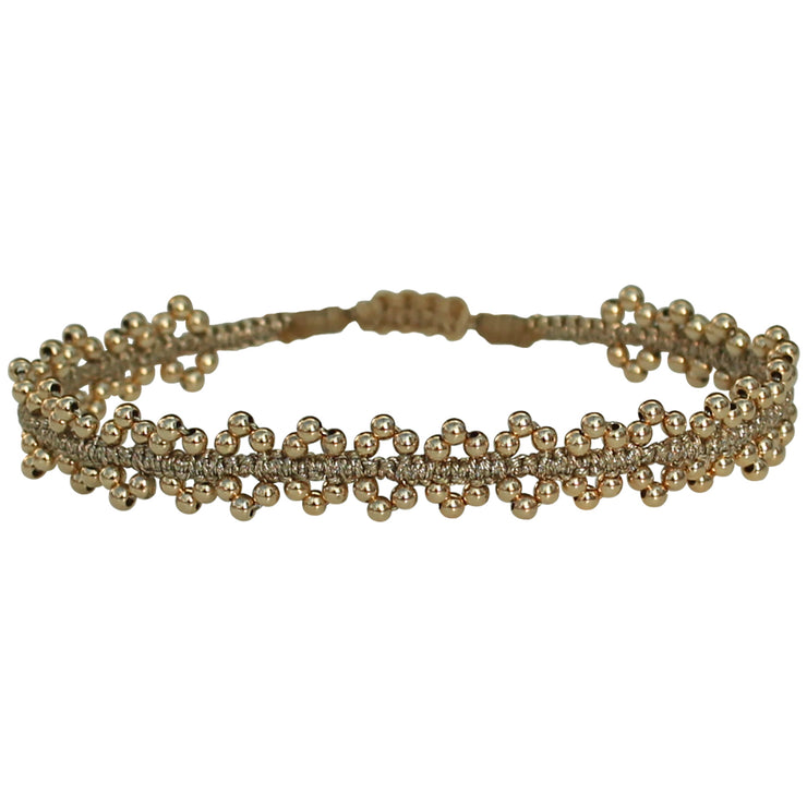 This delicate and beautiful handmade bracelet is handwoven by our team of artisans using 14k gold filled beads and gold metallic threads.   You can wear it with your favourite bracelets all season long.   Details:  - Gold filled beads details   - Gold metallic threads  -Adjustable bracelet  -Can be worn under water   -Width: 8mm