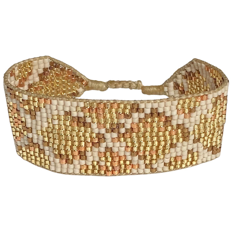 This stunning adjustable bracelet is handwoven using Japanese  glass beads and features snake print patterns in gold tones.  Details:  - Japanese Glass beads  - Italian wax thread  -Adjustable Bracelet   - Width 2,2cm