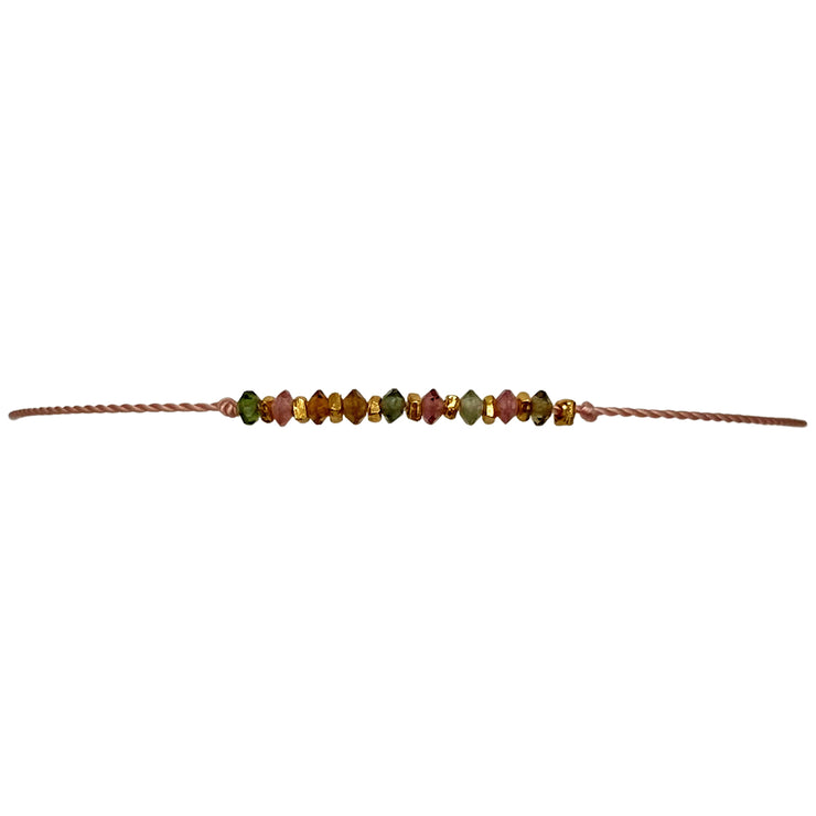 We are absolutely sure that you will fall in love with the new Kora handmade bracelet!! This delicate design has been handwoven in Colombia by our team of artisans using vermeil faceted beads and watermelon tourmaline stones which fills your aura with peace and tranquility. We only use natural stones chosen for their unique beauty, no two are exactly the same, making each design truly one of a kind.  Details:  - Watermelon tourmaline stones  - Vermeil faceted beads  - Width 2mm  -Women bracelet
