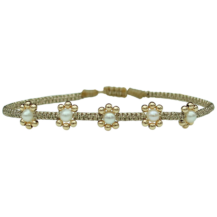 Delicate & feminine, this bracelet is handwoven using metallic gold threads and intermixed freshwater pearls and 14k gold filled beads.  Wear it with your favourite accessories all season long!  Details:  - Metallic threads  - Adjustable bracelet   - Take care of your jewellery by keeping it dry and avoid spraying fragrances directly on to it.   - It comes with a card and a gift box 