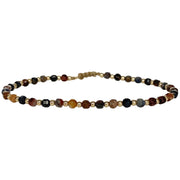 This delicate jewel is handmade using gold filled beads and Pietersite semi-precious stones. This beauty will be one of your favorite bracelets as you can wear it with any accessories or outfits. Give to your looks a touch of elegance and sparkle !  Details:  - Pietersite semi-precious stones   - 14 K gold filled beads  -Adjustable bracelet  -width: 2m  -Can be worn in the water