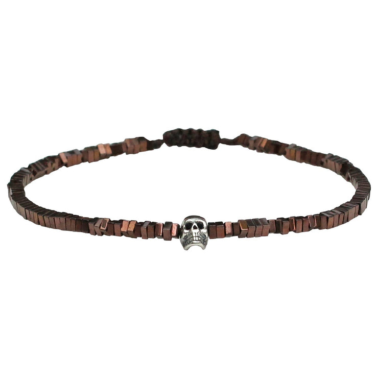 This handwoven bracelet for him is made using a single row of hematite stones and features a central sterling silver skull detail. This bracelet add attitude to your everyday style and looks great stacked with your other favourite pieces.  Details:      Hematite stones     Sterling silver skull     Adjustable handwoven bracelet     Width 2mm 