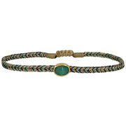 Delicate & feminine, this bracelet is handwoven using metallic gold and green threads and features a green onyx precious stone centrepiece. Onyx stones are symbols of happiness.  Wear it with your favourite accessories all season long, and with its adjustable pull cord you will always have the perfect fit!  Details:  - Onyx precious stone  - Vermeil setting   -Metallic threads  -Adjustable bracelet 