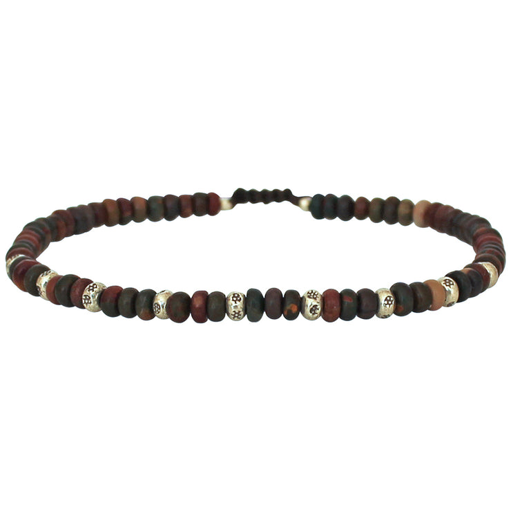 This cool bracelet is adorned with jasper stones. The highlights are silver Beads that have been graphically elaborately designed by hand.   Details:  -Men&