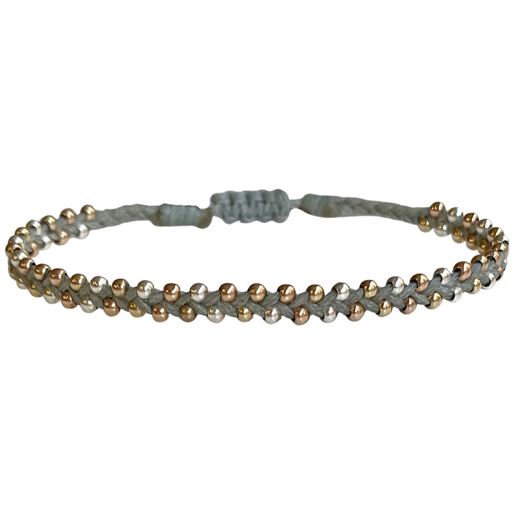 This delicate and beautiful bracelet is handwoven by our team of artisans using 14K gold and rose gold filled beads and 925 silver beads.  You can wear it with your favourite bracelets all season long.   Details:  -14k gold and rose gold beads details   -925 sterling silver  -Adjustable bracelet  -Width: 3mm  -Can be worn on water