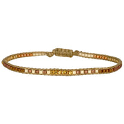 Handwoven in Colombia, this feminine bracelet features a single row of Japanese glass beads in gold and brown tones and gold faceted beads  Wear this stylish bracelet alone or as a part of a bracelet layering combination, with your favourite jeans & t-shirt!  Details:  -Gold faceted beads  - Japanese glass beads  - Width: 2mm  - Adjustable bracelet 