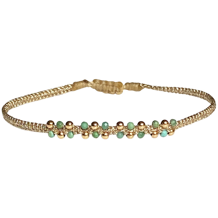 This stunning Nora bracelet will look great on everyone. It can be worn from day to night and, with the dramatic centre of Turquoise semi-precious stones & 14K gold filled beads, it will illuminate any look. It has been handwoven in Colombia by our team of artisans and features an adjustable pull cord to ensure the perfect fit for all wrists.      Turquoise semi-precious stones     14K gold filled beads     Handwoven metallic threads     Adjustable pull cord     Width 4mm