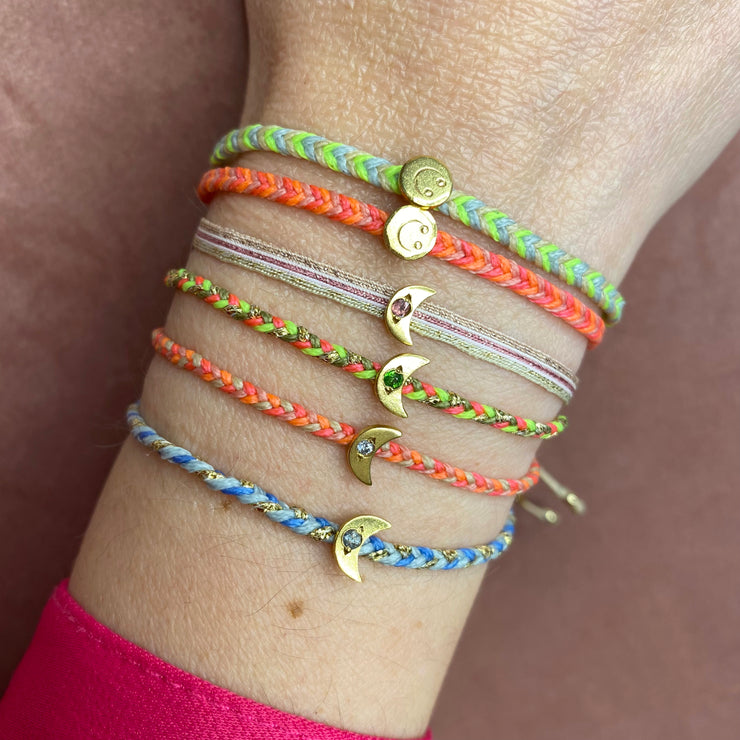 HAPPY HANDMADE BRACELET IN NEON COLOURS FEATURING A GOLD SMILEY CHARM