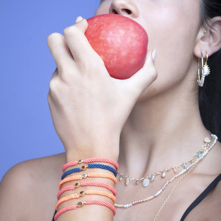 This gorgeus bracelet is handwoven by our team of master artisans using macramé techniques. An impressive Blue Topaz is the centerpiece of this iconic design. It&