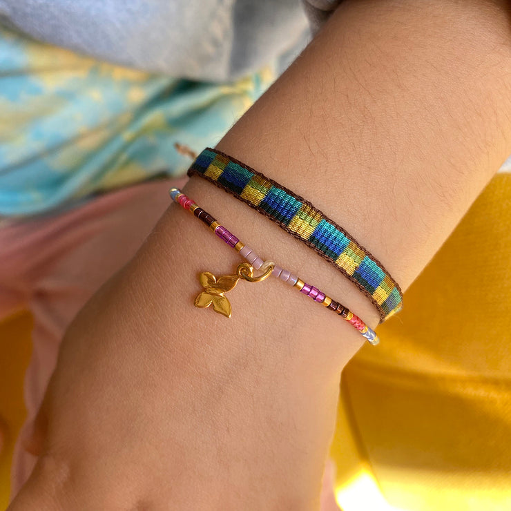 This beautiful kids bracelet is handwoven using Japanese glass beads and a 14k gold vermeil on 925 sterling silver butterfly charm.    Wear it with your favourite accessories!  Details:  -Kids bracelet  - Japanese glass beads  - 14k gold vermeil on 925 sterling silver charm   -Width: 2mm  -Adjustable bracelet