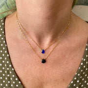 This delicate necklace is designed to be layered with other styles and looks beautiful on its own, too. It's hadnmade using a 14 k gold filled chain and a black spinel semi-precious stone as a center piece.      14 K gold filled chain and clasp closure     Measures 38cm + 2cm extension     Handmade necklace     Black spinel semi-precious stone